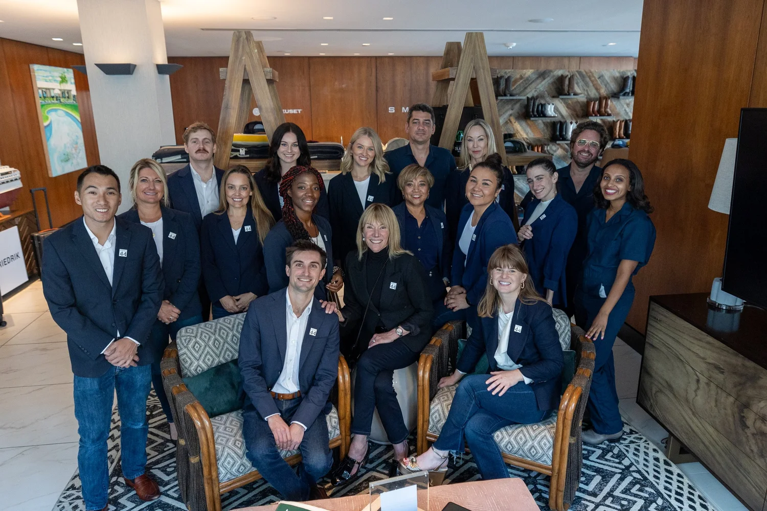 Team in navy suits at an indoor gathering