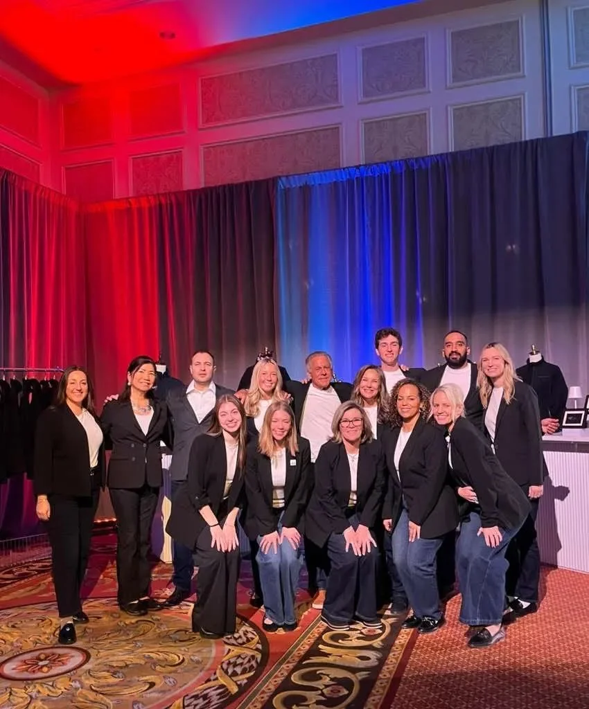 Team in suits at an event space
