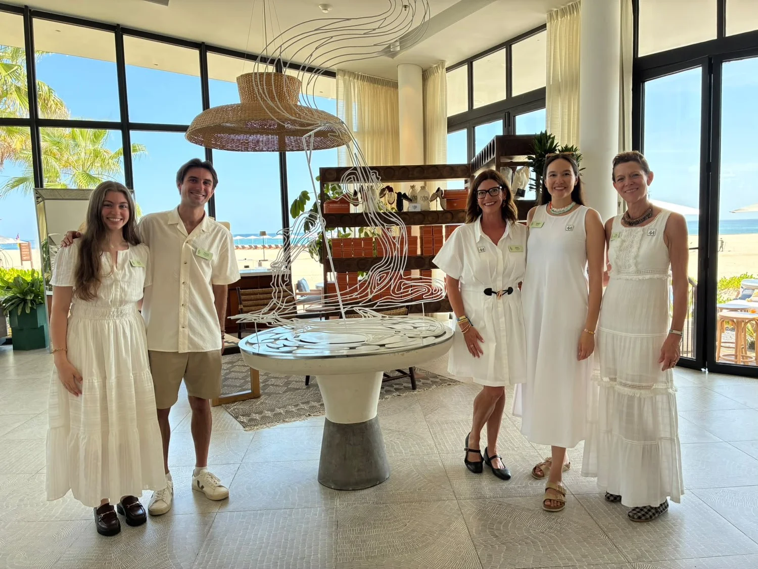 Guests dressed in white in a sunlit suite