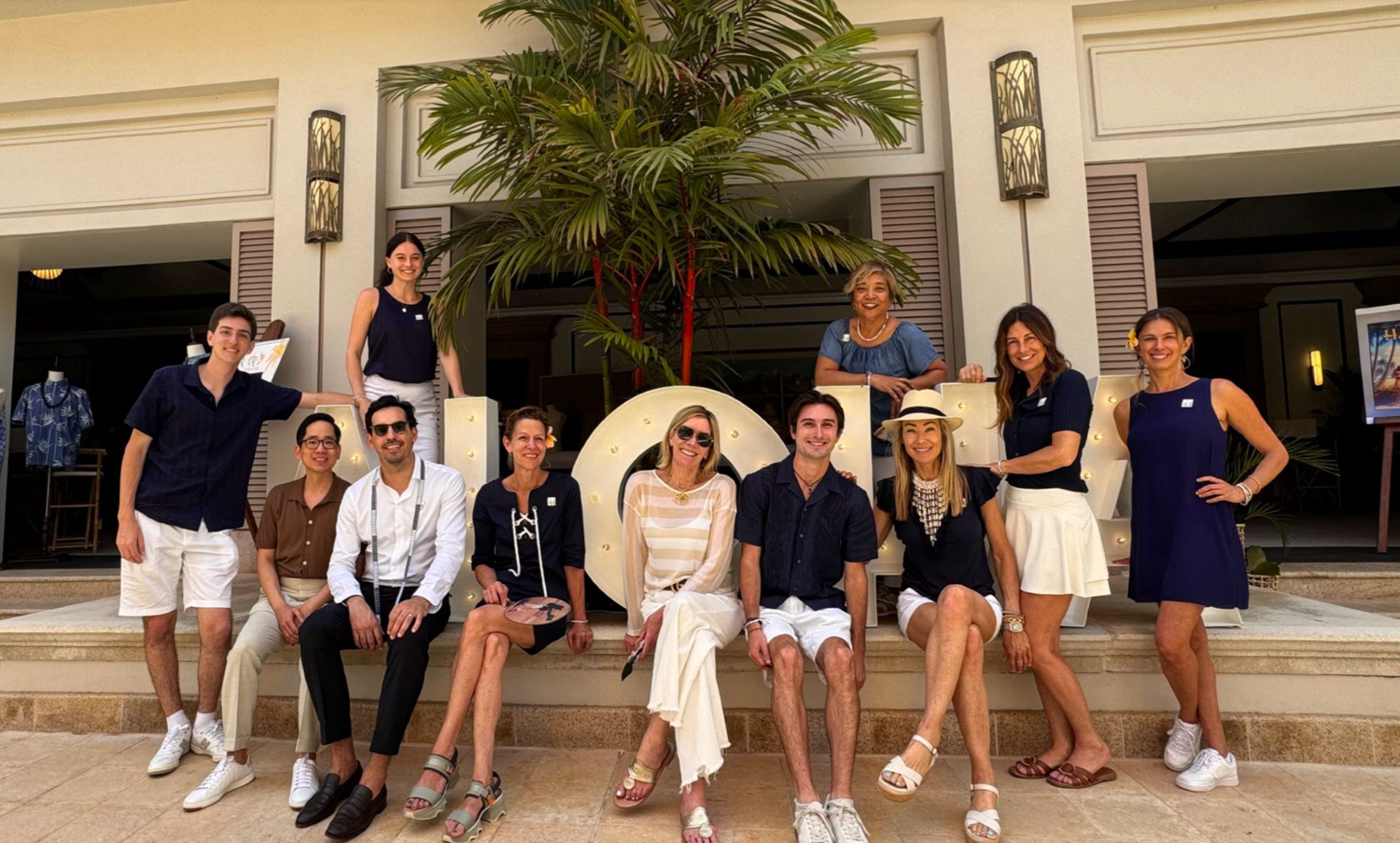 Team gathered on the steps of a resort