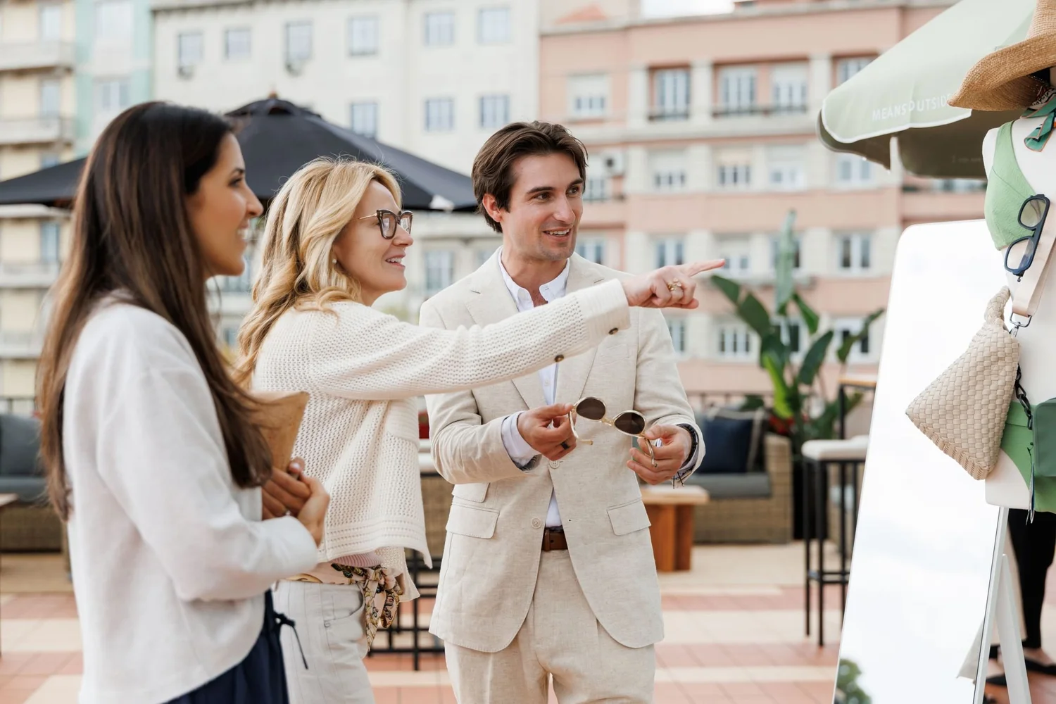 Guests in white raising a toast outdoors