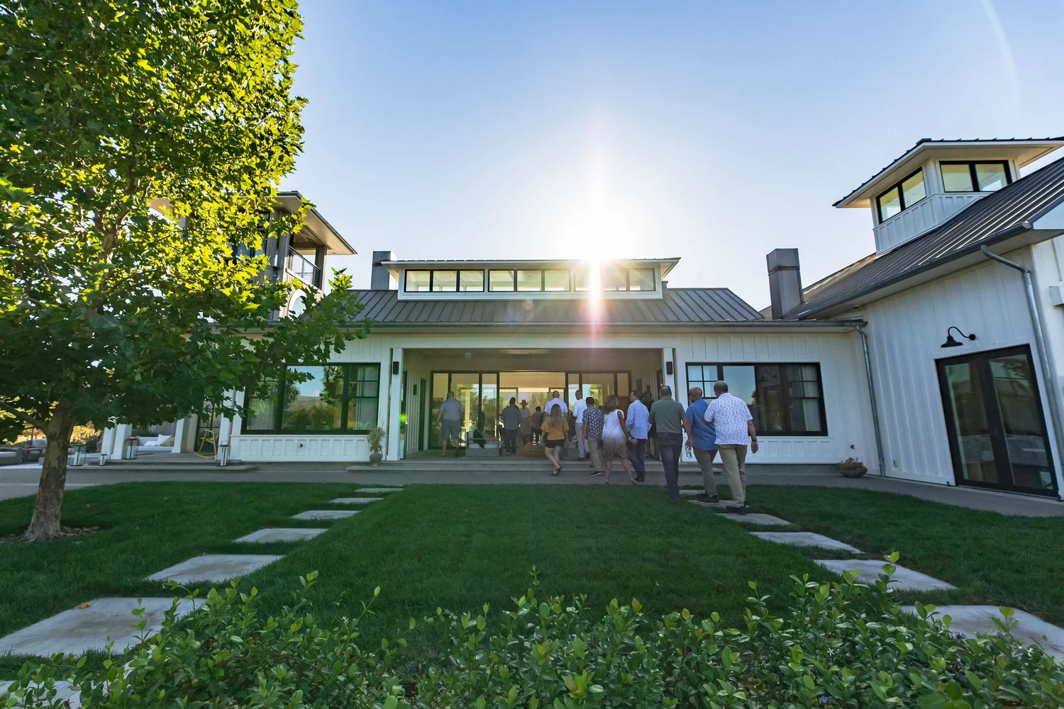 Guests gathered on the lawn of a modern estate