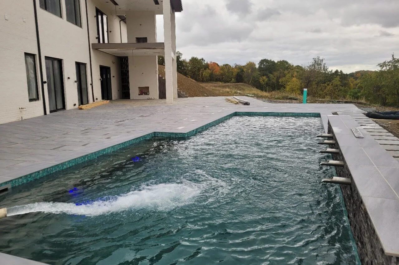 The pool filling, with the scuppers along the raised wall