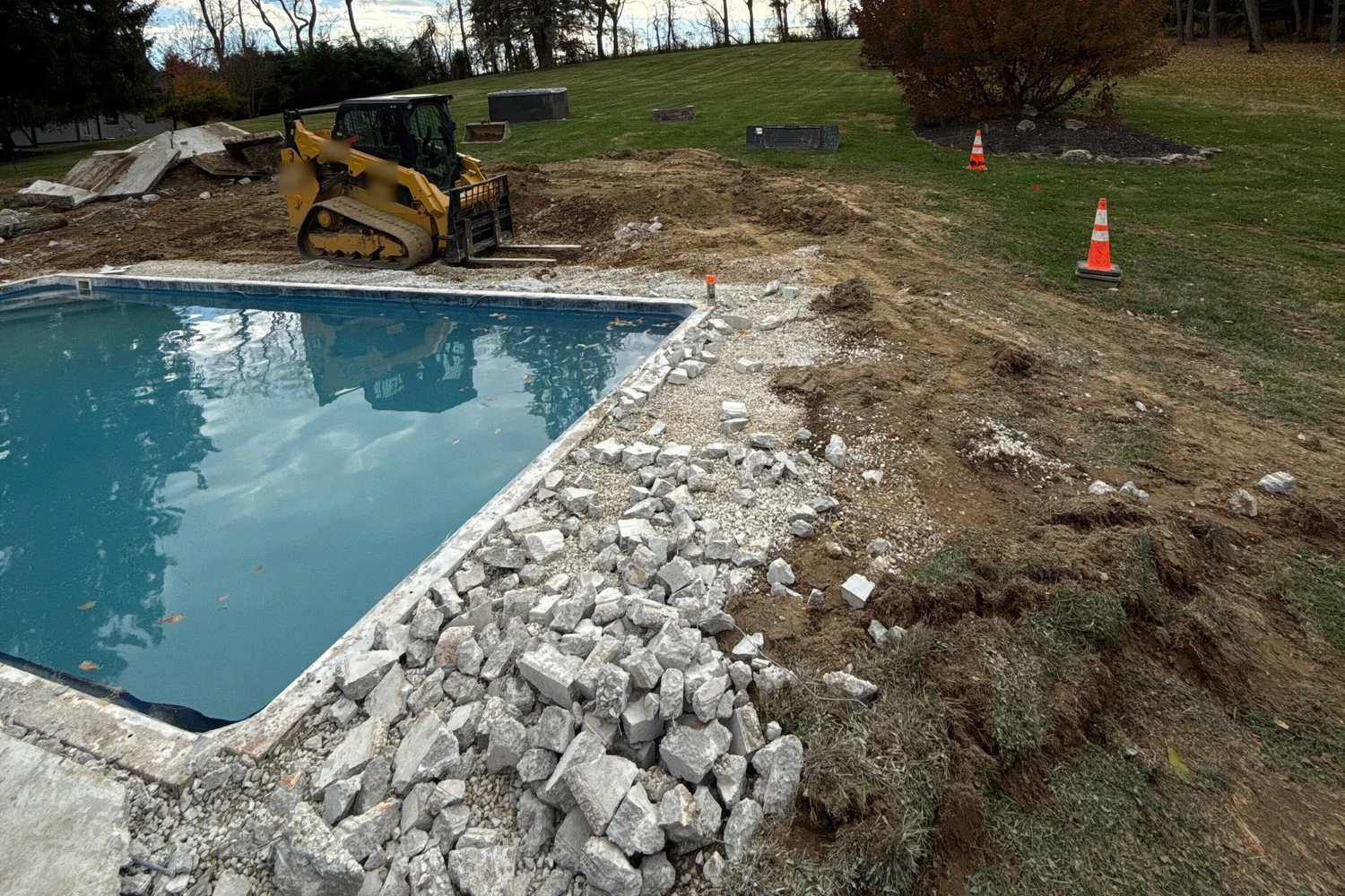 The old deck and surround broken out around the existing pool