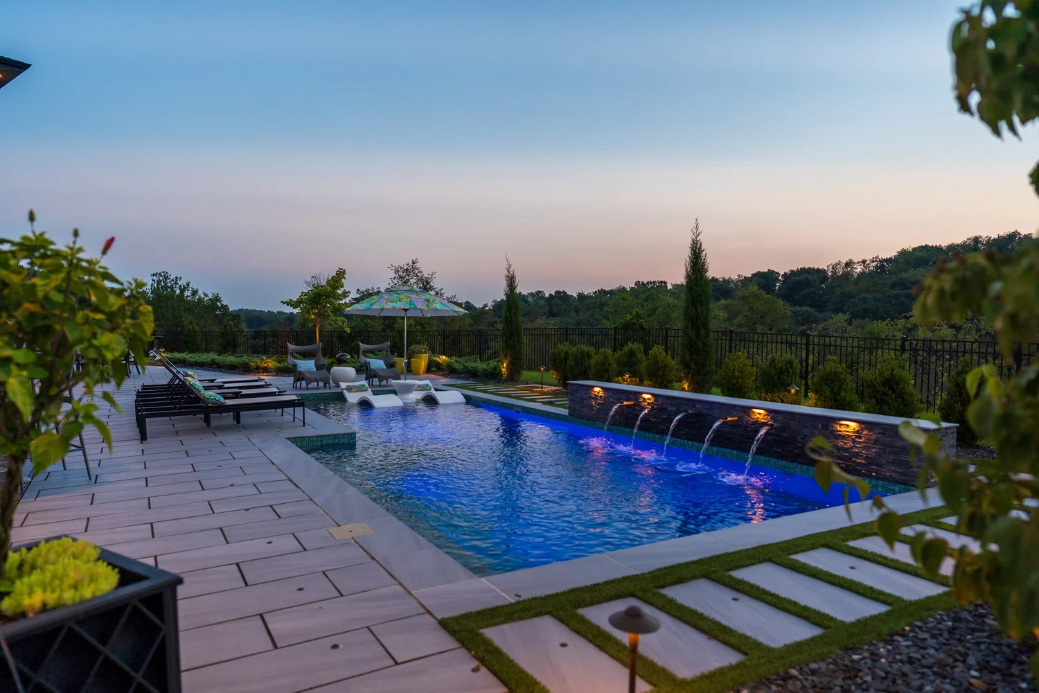 The pool and its scupper wall at sunset, with the valley beyond