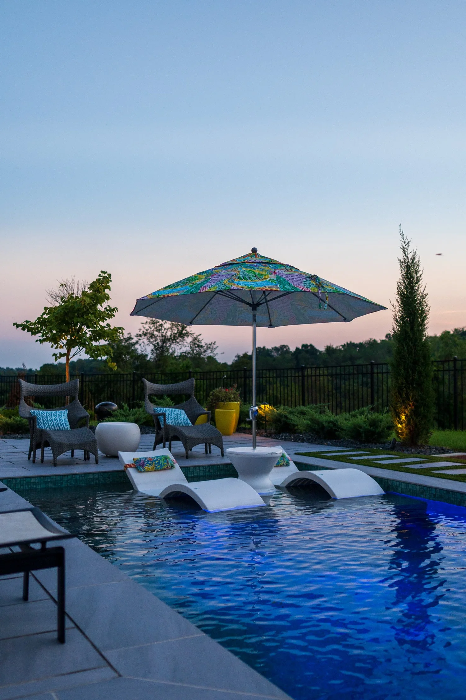 Loungers on the sun shelf under an umbrella at sunset