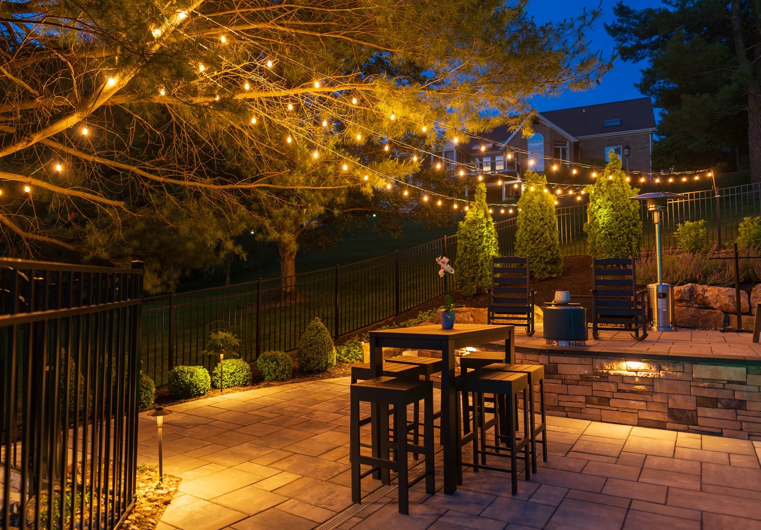 The dining area under string lights at dusk