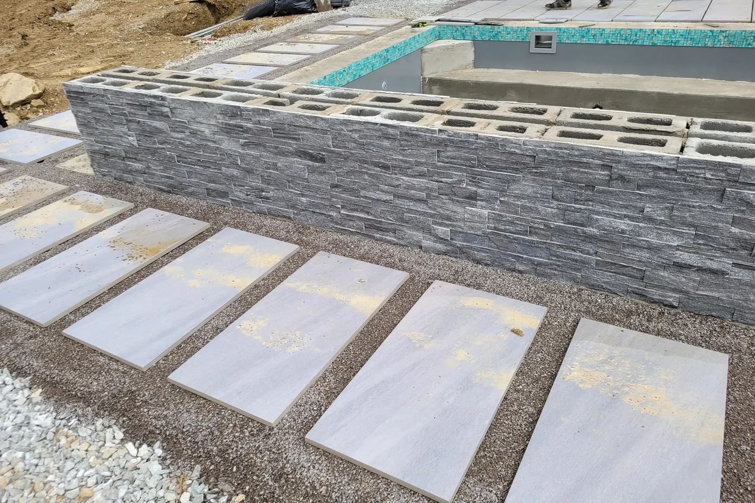 Stone veneer on the raised wall and the first deck pavers