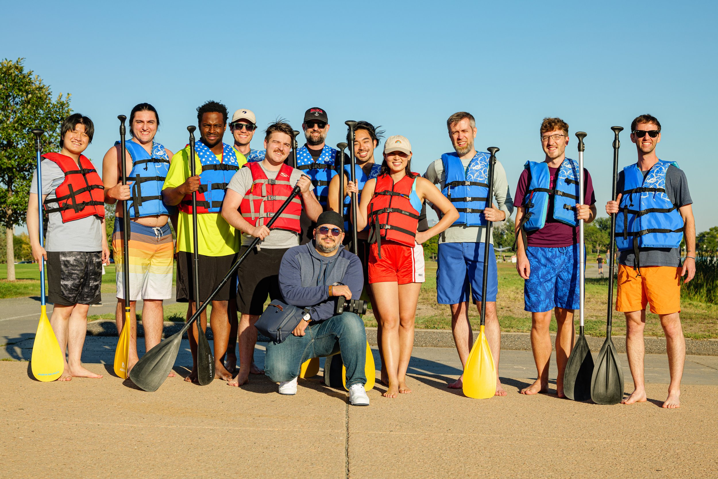 Team gathered for a paddle boarding event