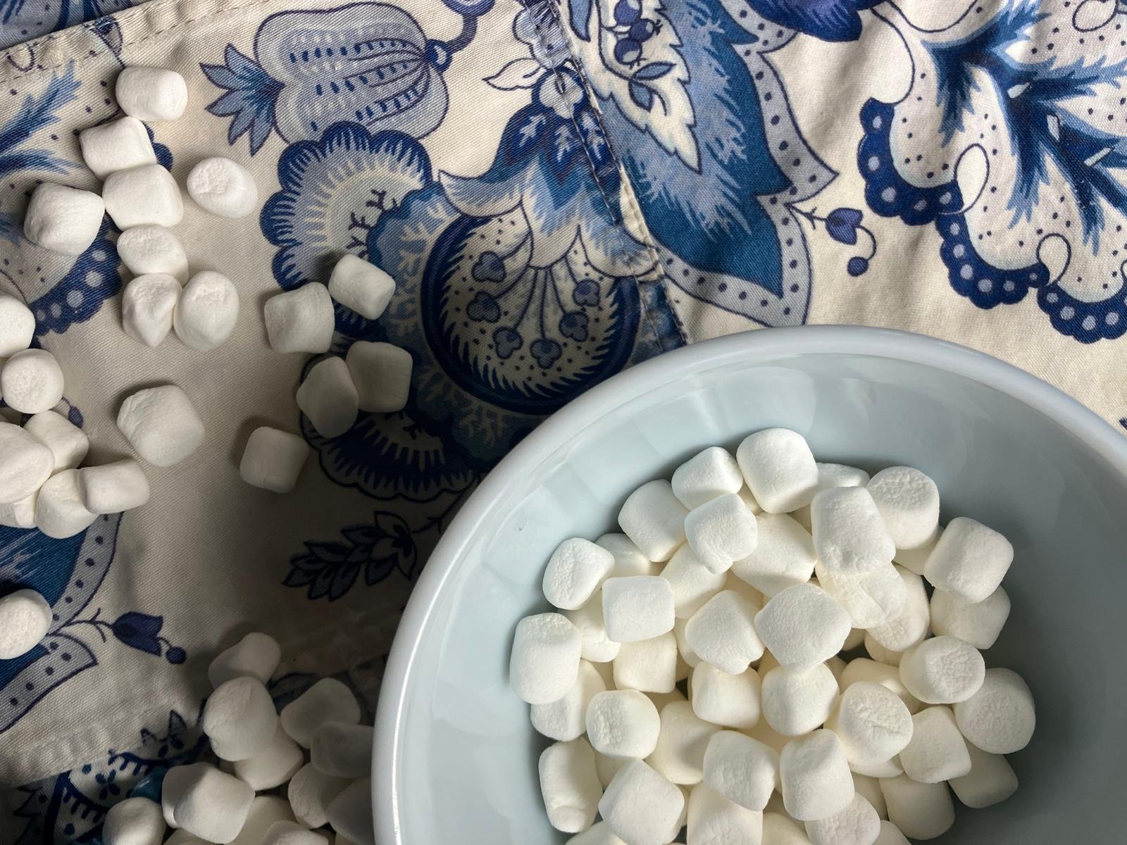 Bag of mini marshmallows spilling onto surface
