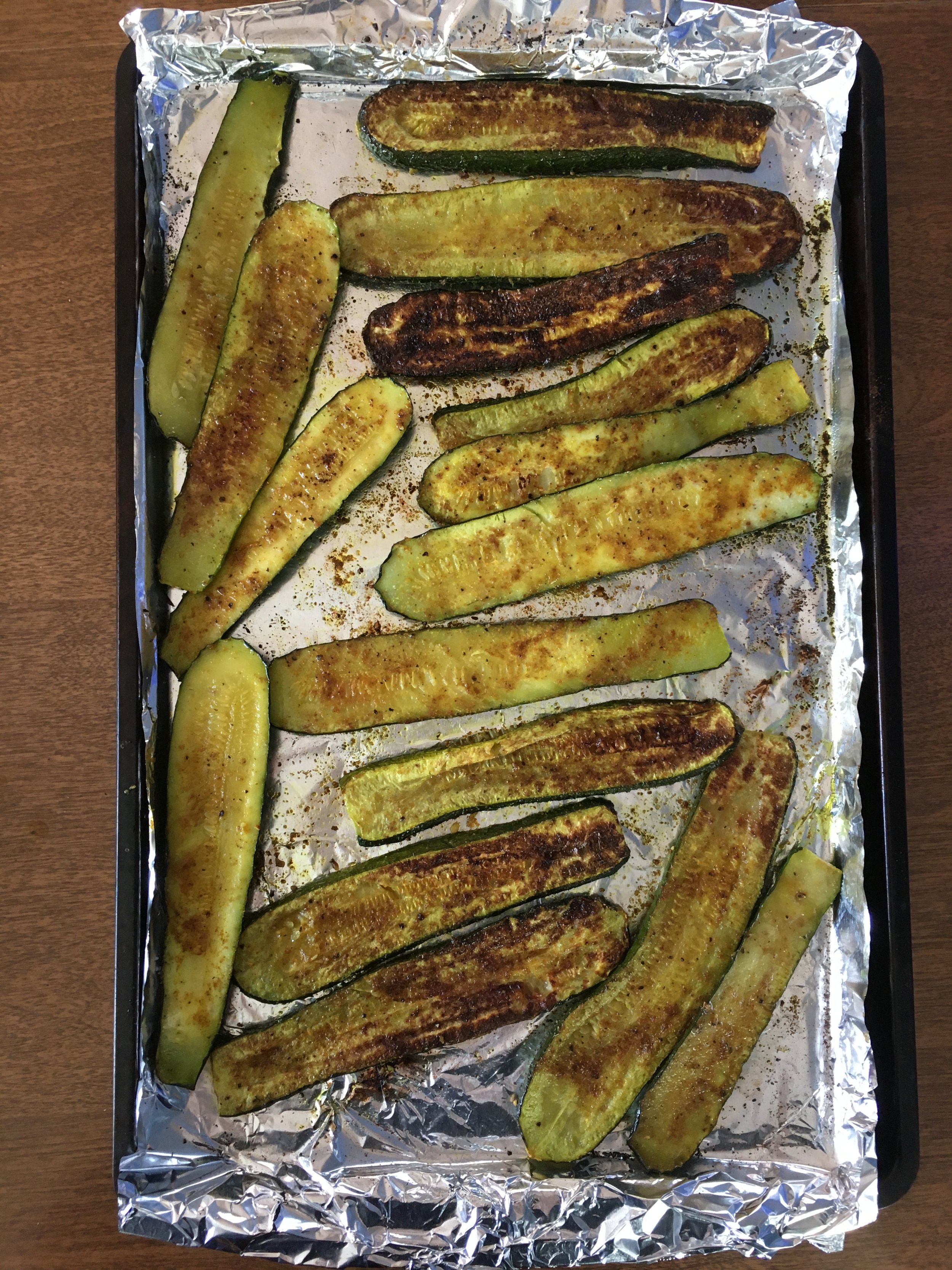Roasted zucchini slices on a pan for healthy weight loss meal preps from staten island health coach megan gaul
