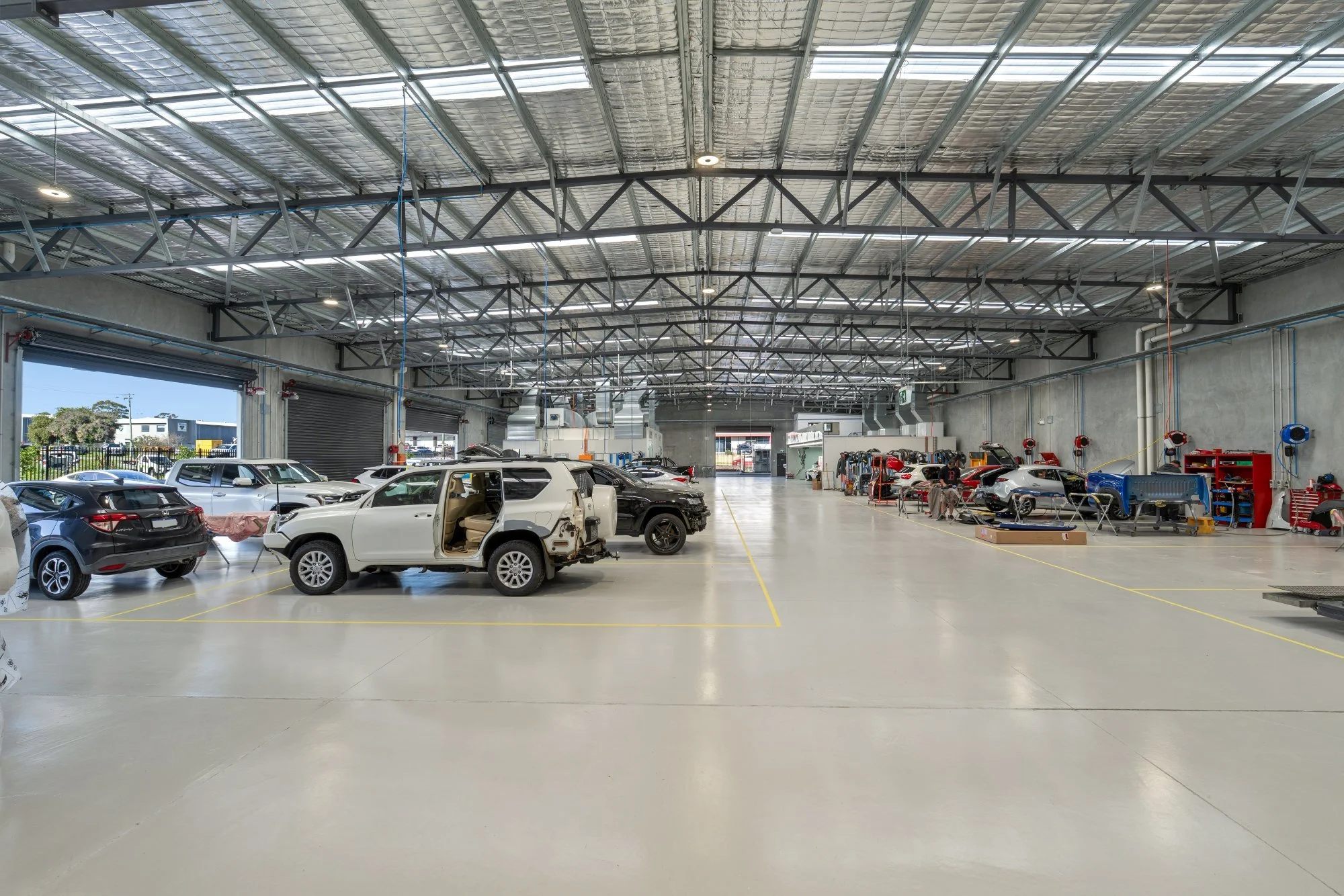 Main workshop floor with cars in repair