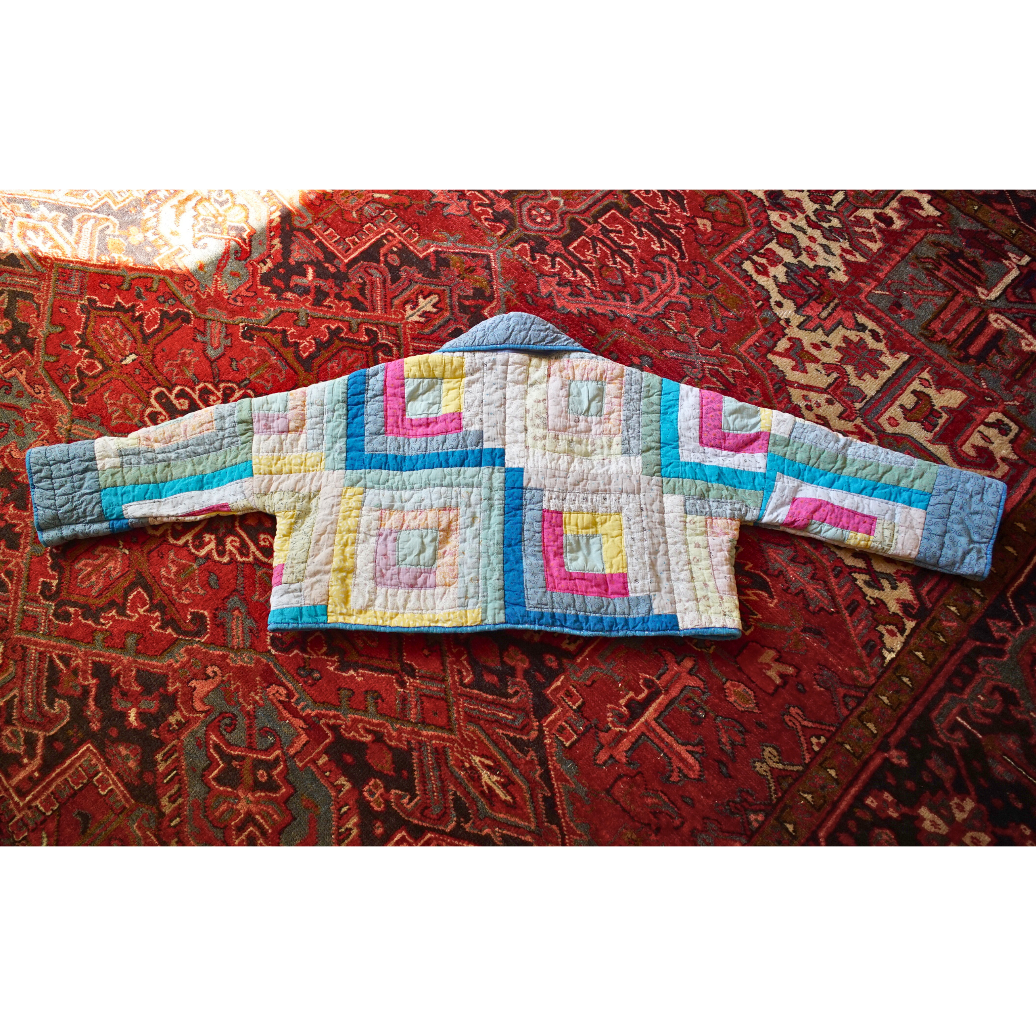 Back panel of a handmade upcycled quilt coat showing the vintage quilt pattern