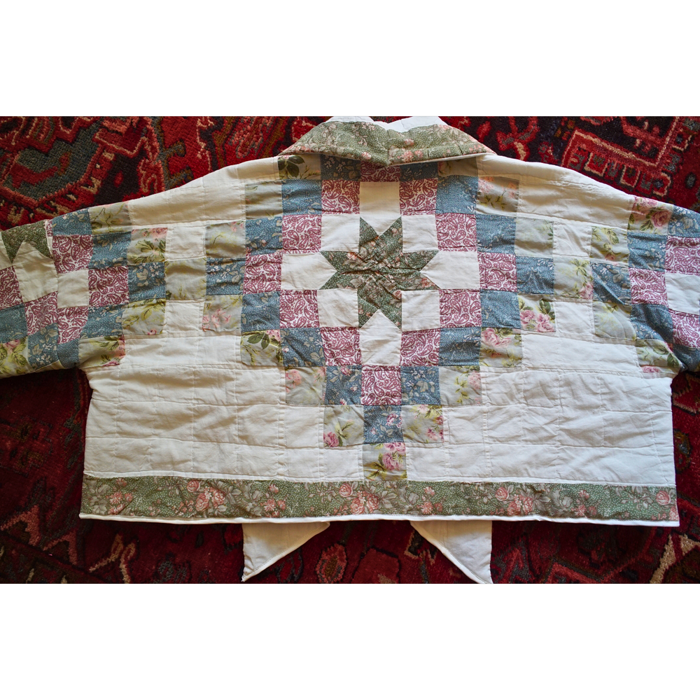 Back panel of a handmade upcycled quilt coat showing the vintage quilt pattern