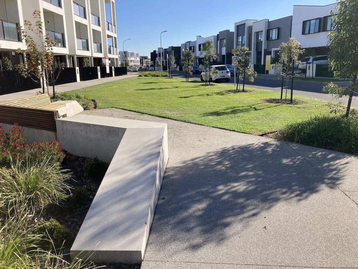 Landscaped estate streetscape with planted beds and mown turf