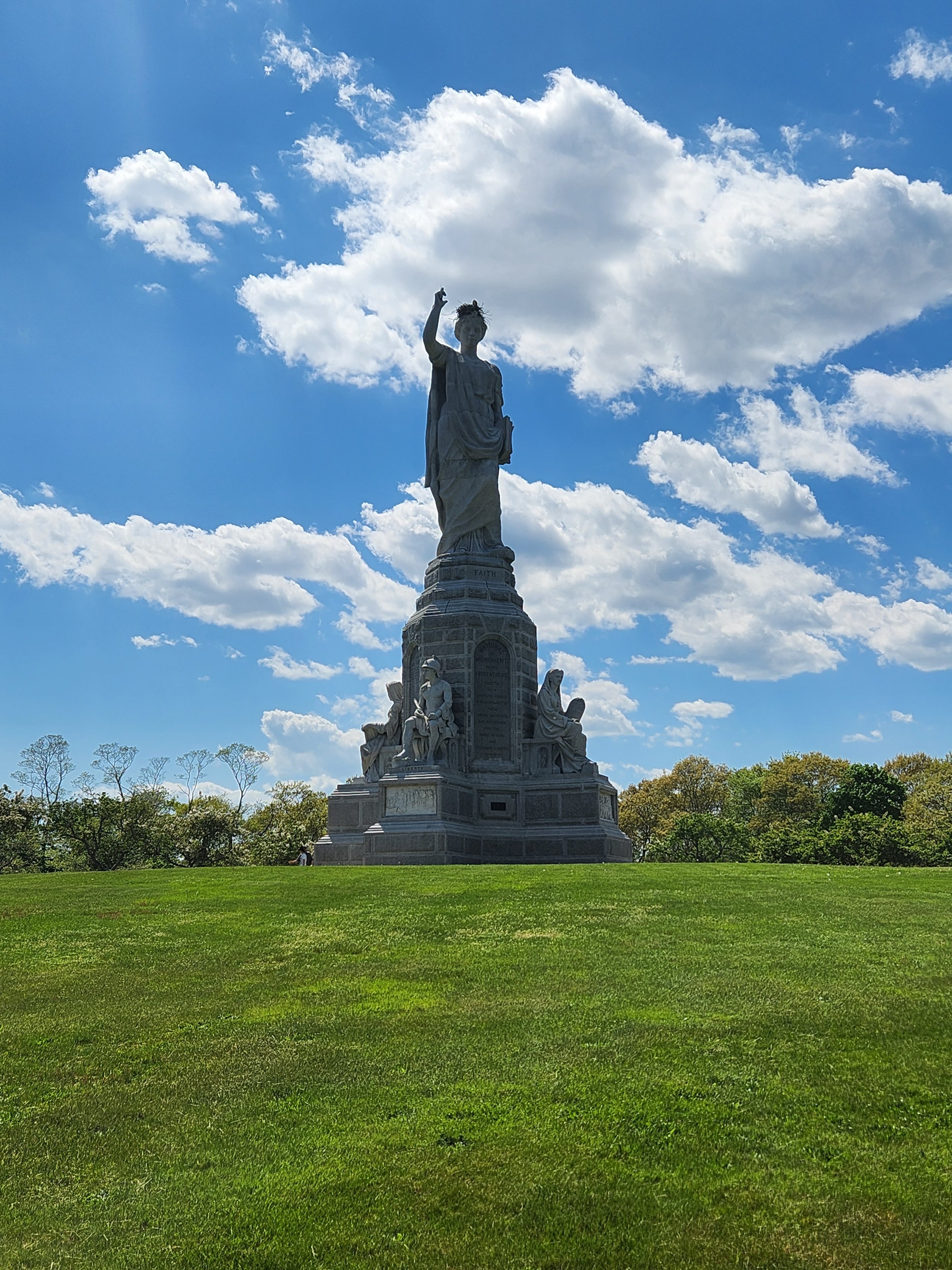 National Monument to the Forefathers rising above a grassy lawn in Plymouth