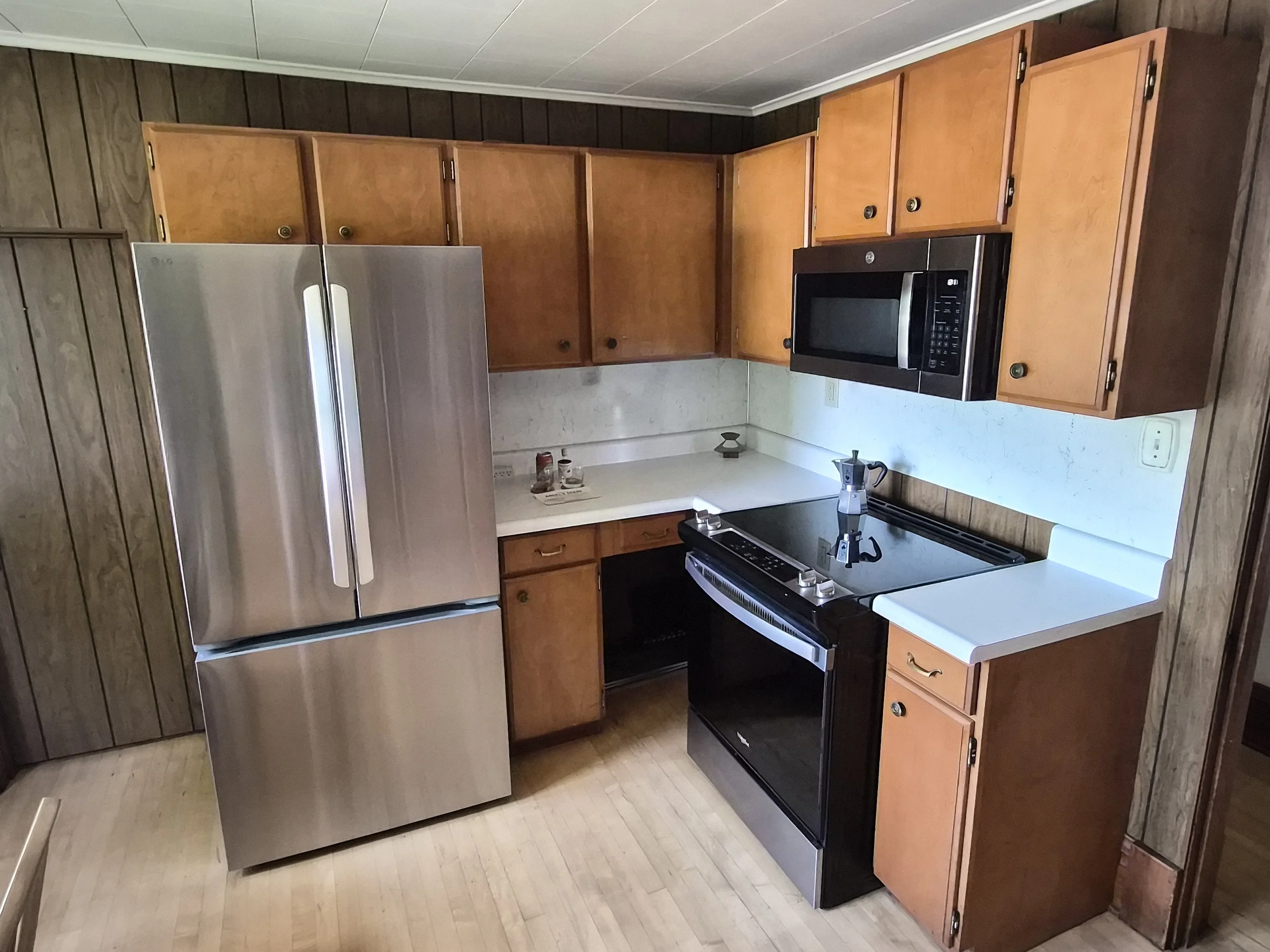 Full kitchen at The Angel's Share with refrigerator, range and microwave