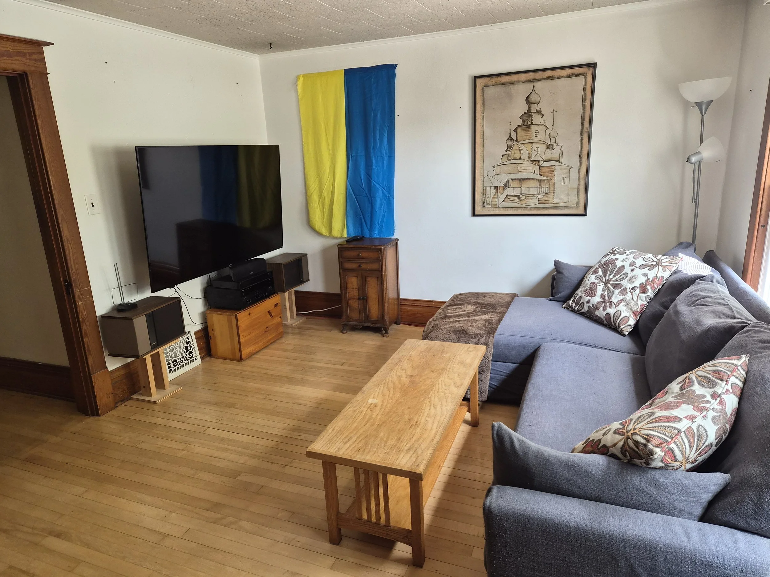 Living room at The Angel's Share with sectional seating and a large television