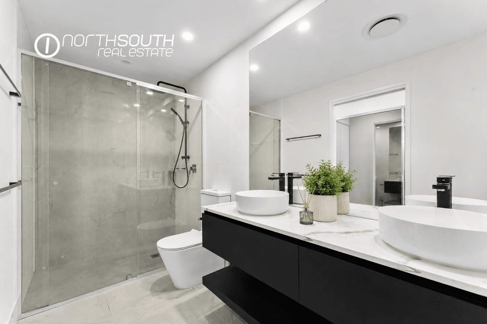 Bathroom with walk-in shower and floating vanity in apartment 5608, Waterpoint Residences