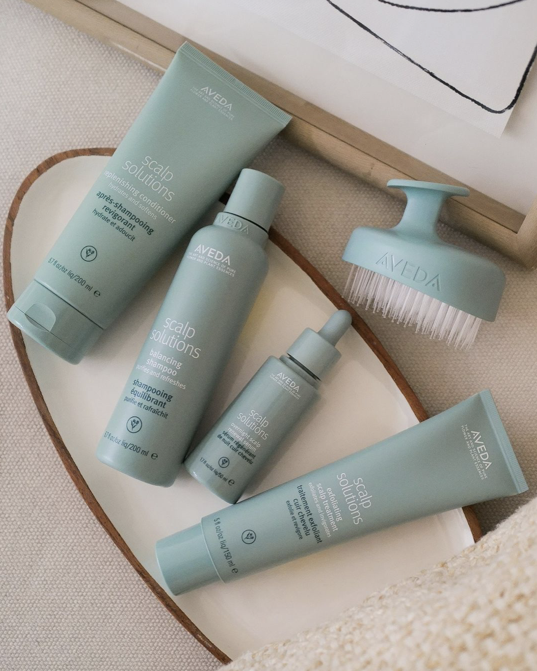 Tangerine Salon stylist performing scalp consultation and treatment at DFW Aveda salon