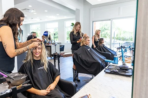Charlotte Tilbury artists and Tangerine Salon stylists collaborating on Dallas Cowboys Cheerleaders makeovers