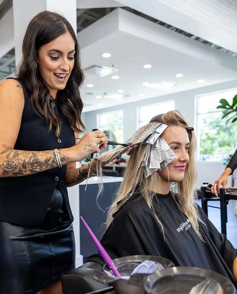 Tangerine Salon stylist working with precision for the Dallas Cowboys Cheerleaders