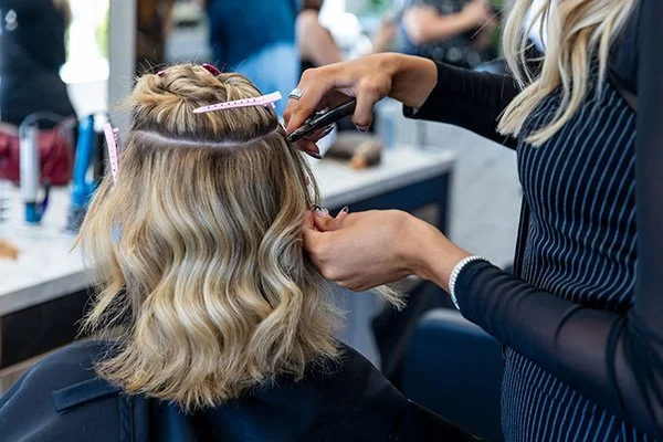 Bellami hair extensions transformation showing full-volume blonde at Tangerine Salon Dallas