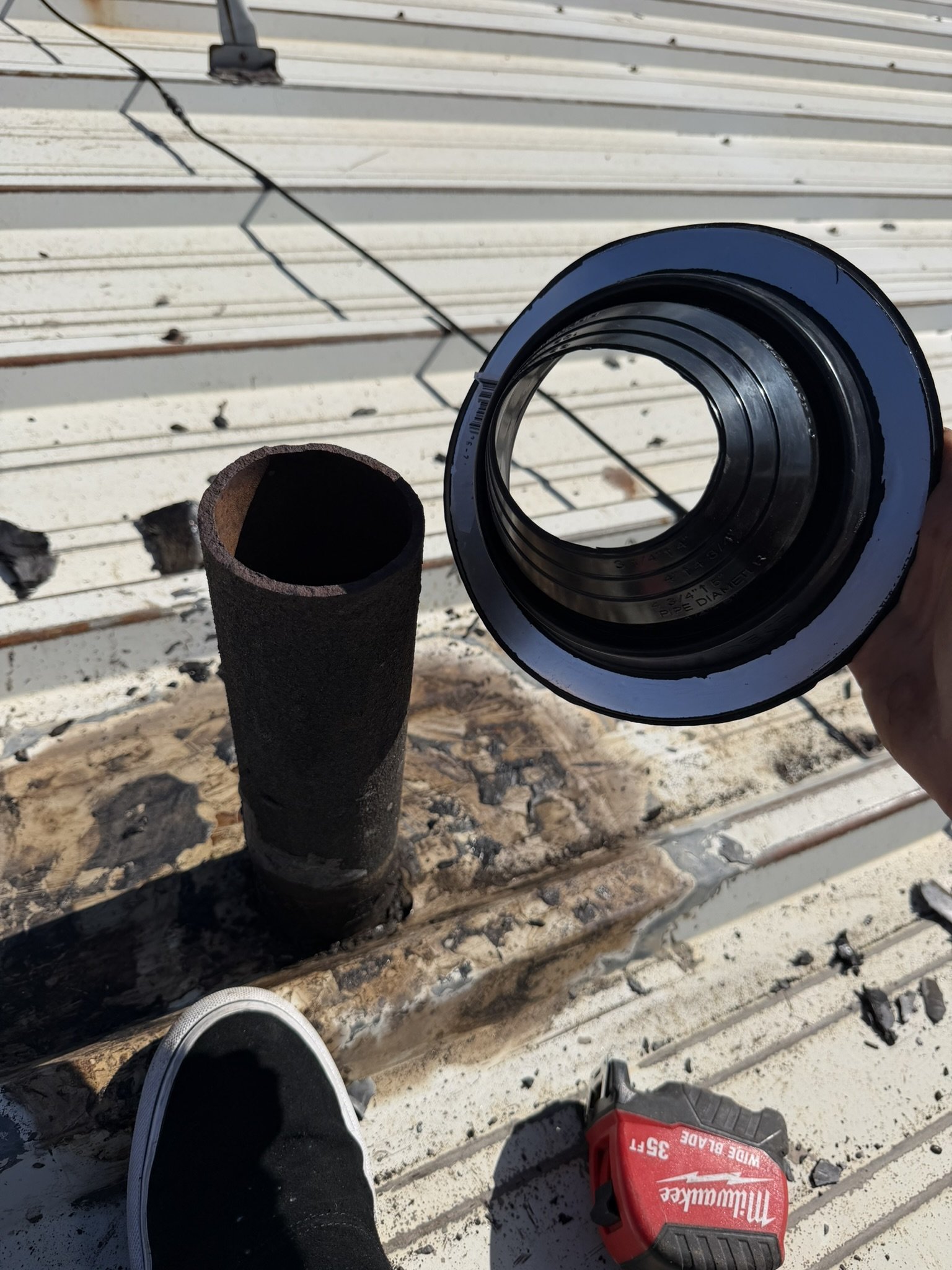 Underside of a new pipe boot showing its flexible flashing base.