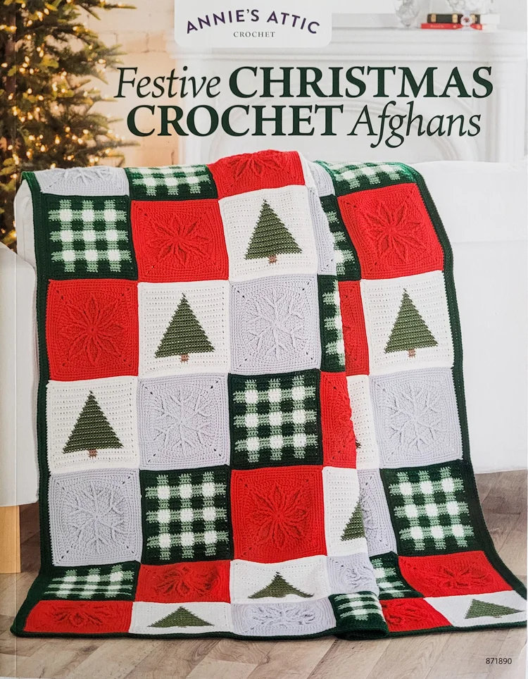 Cover of the book Festive Christmas Crochet Afghans from Annie's Attic. The blanket is made with large blocks: one is green and white plaid, one is red with a raised poinsettia, one is gray with a raised snowflake, and one is white with a pine tree.