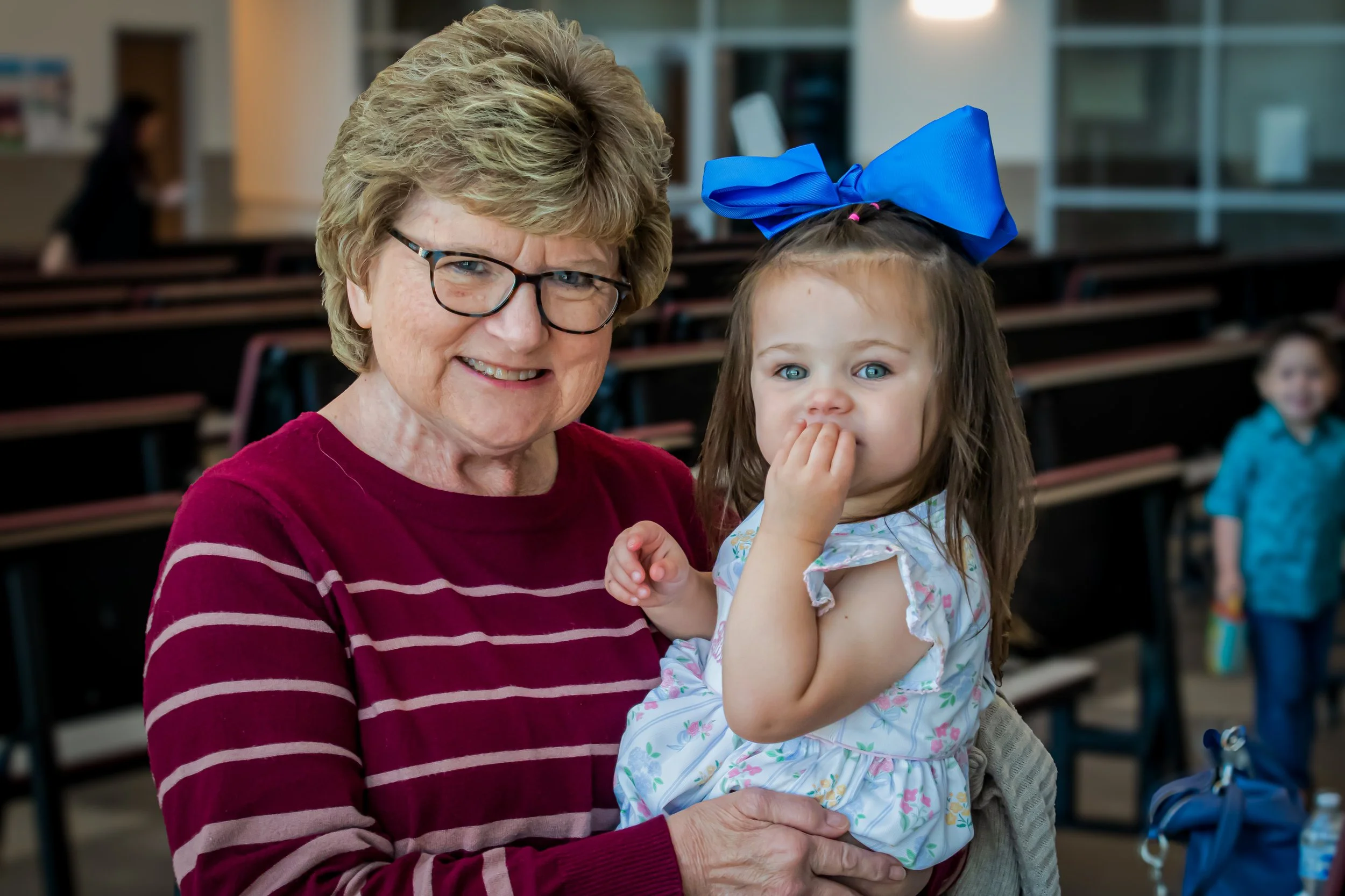 Young child and grandmother smiling church nursery.