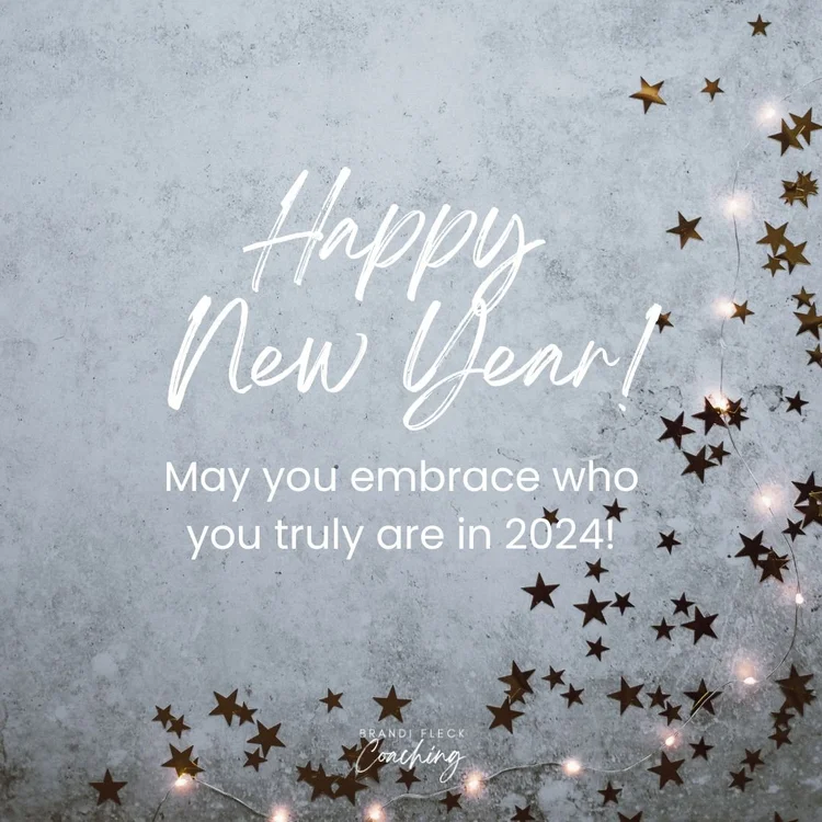 The words happy-new-year on a gray background with gold paper stars and fairy lights.