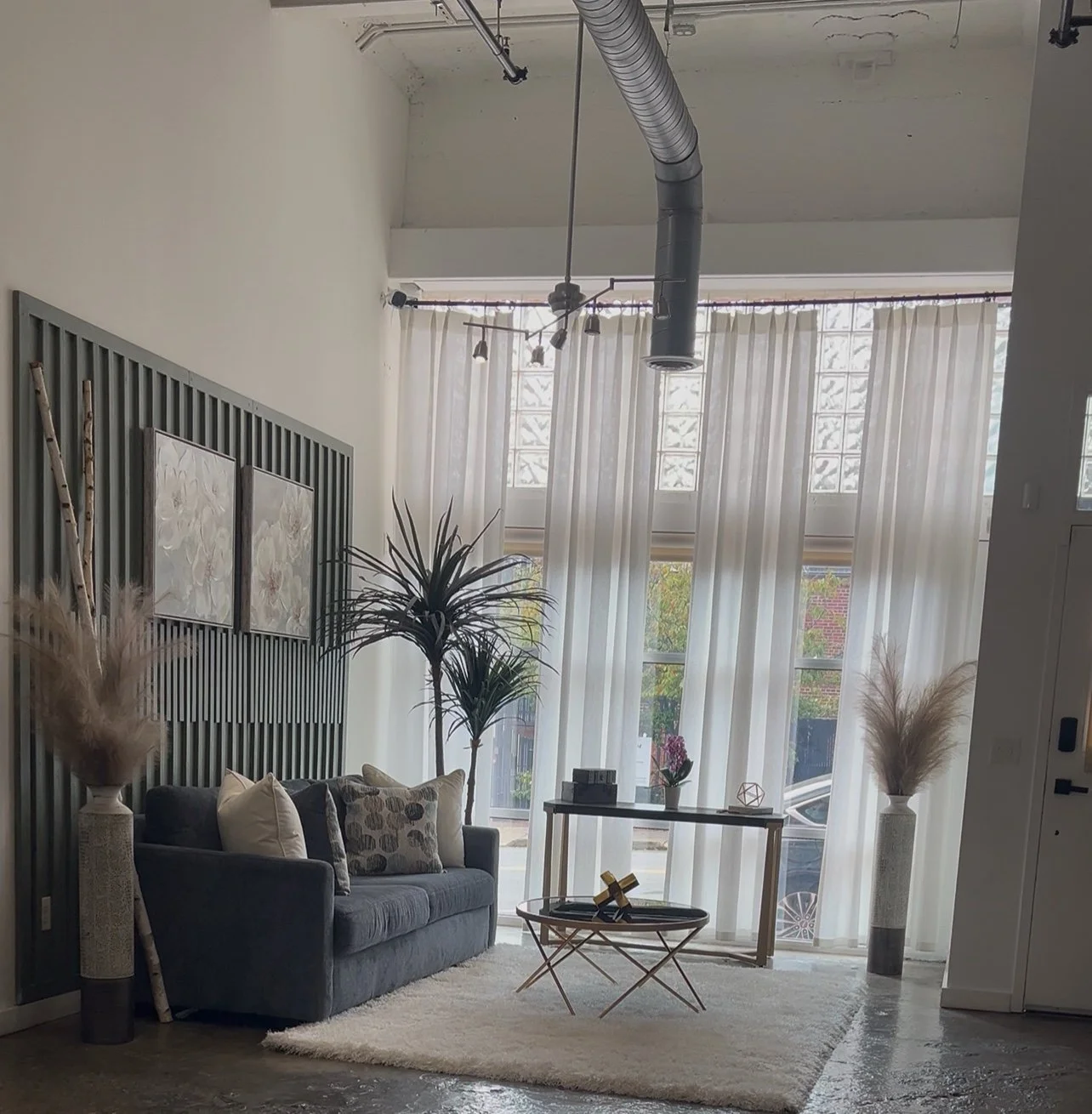 Front-window lounge with a blue-gray sofa.