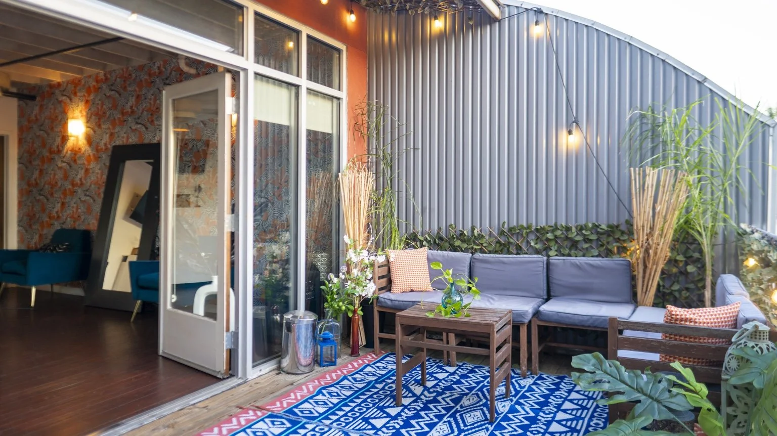 Furnished patio seating and string lights outside the studio.
