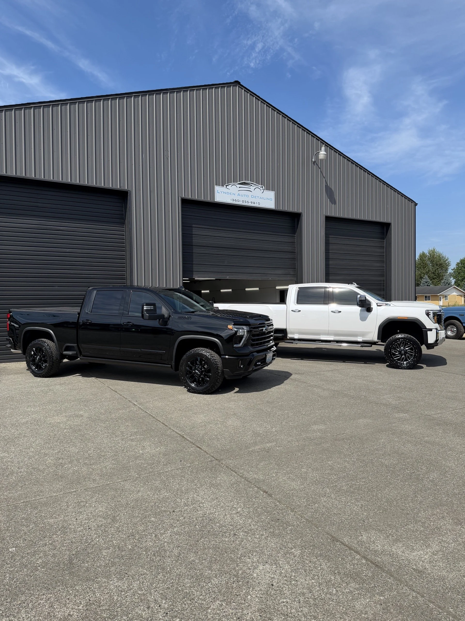 Lynden Auto Detailing shop with two detailed trucks