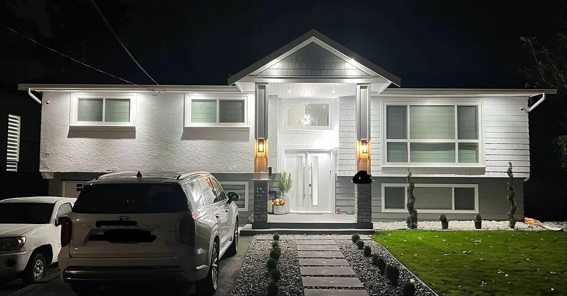 Renovated Lower Mainland home with completed exterior electrical work and lighting.