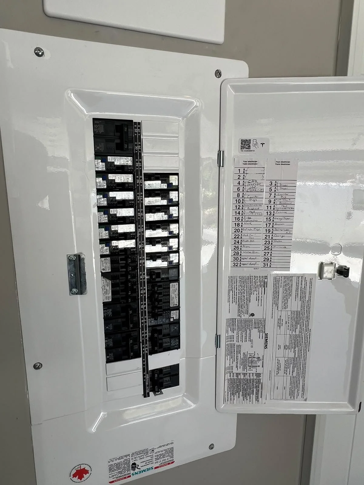 Open breaker panel with EV charger electrical connections