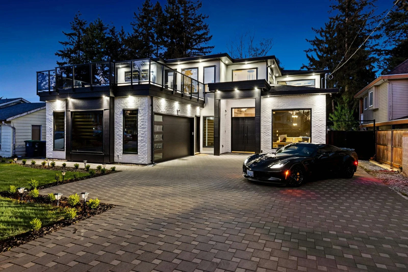 Surrey home exterior at night with pot lights installed by Hundel Electric