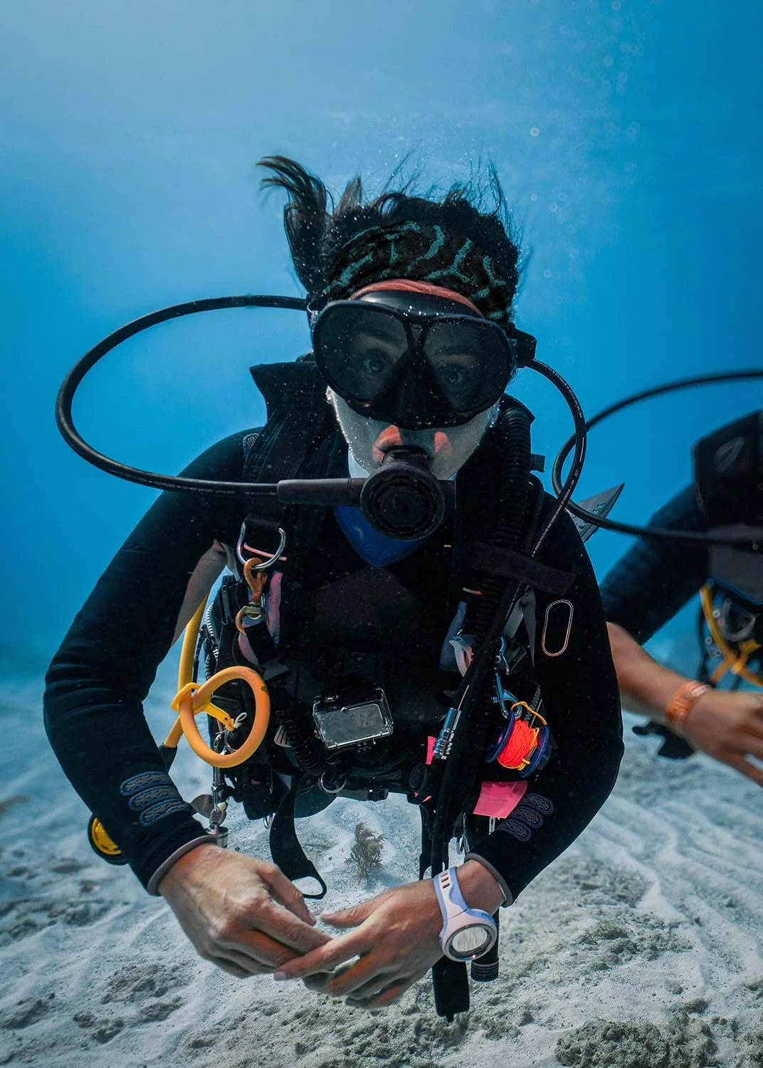 Scuba diver wears headband to protect hair while diving
