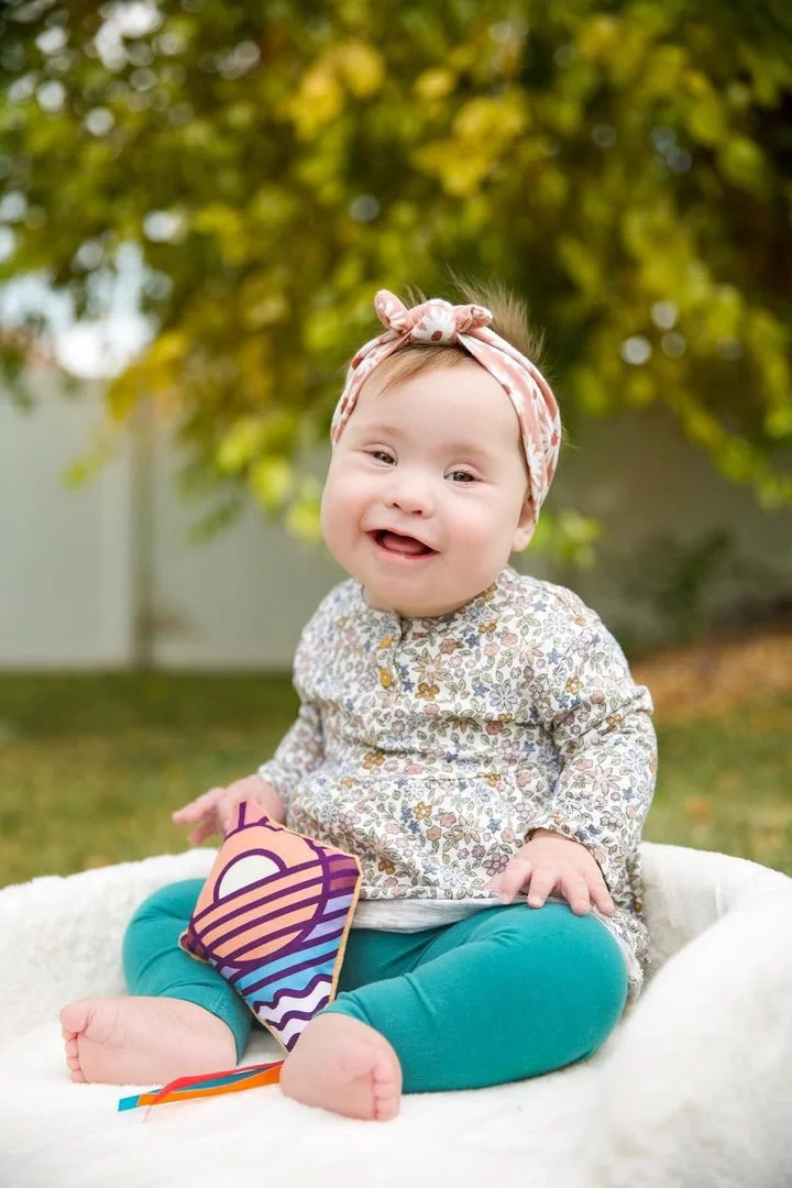 Baby with a toy kite from a Rising Kites resource bag