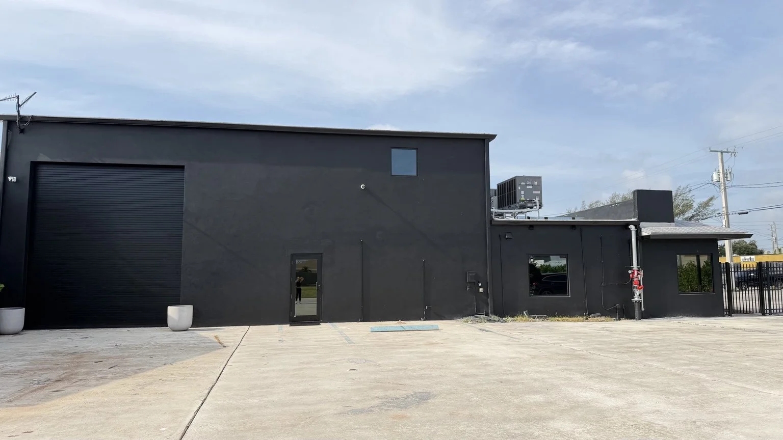 Black garage-side façade before the abstract exterior mural was painted