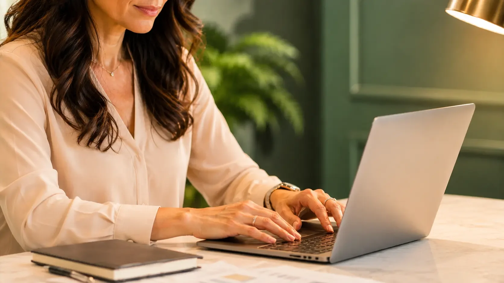 Healthcare practice owner reviewing analytics data on a laptop screen, warm amber lamp light from the side, deep green background, focused editorial detail portrait