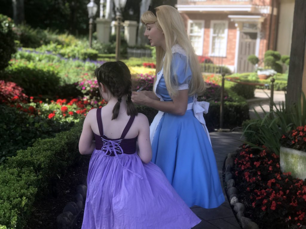 My oldest visiting with Alice in Wonderland at Epcot. 