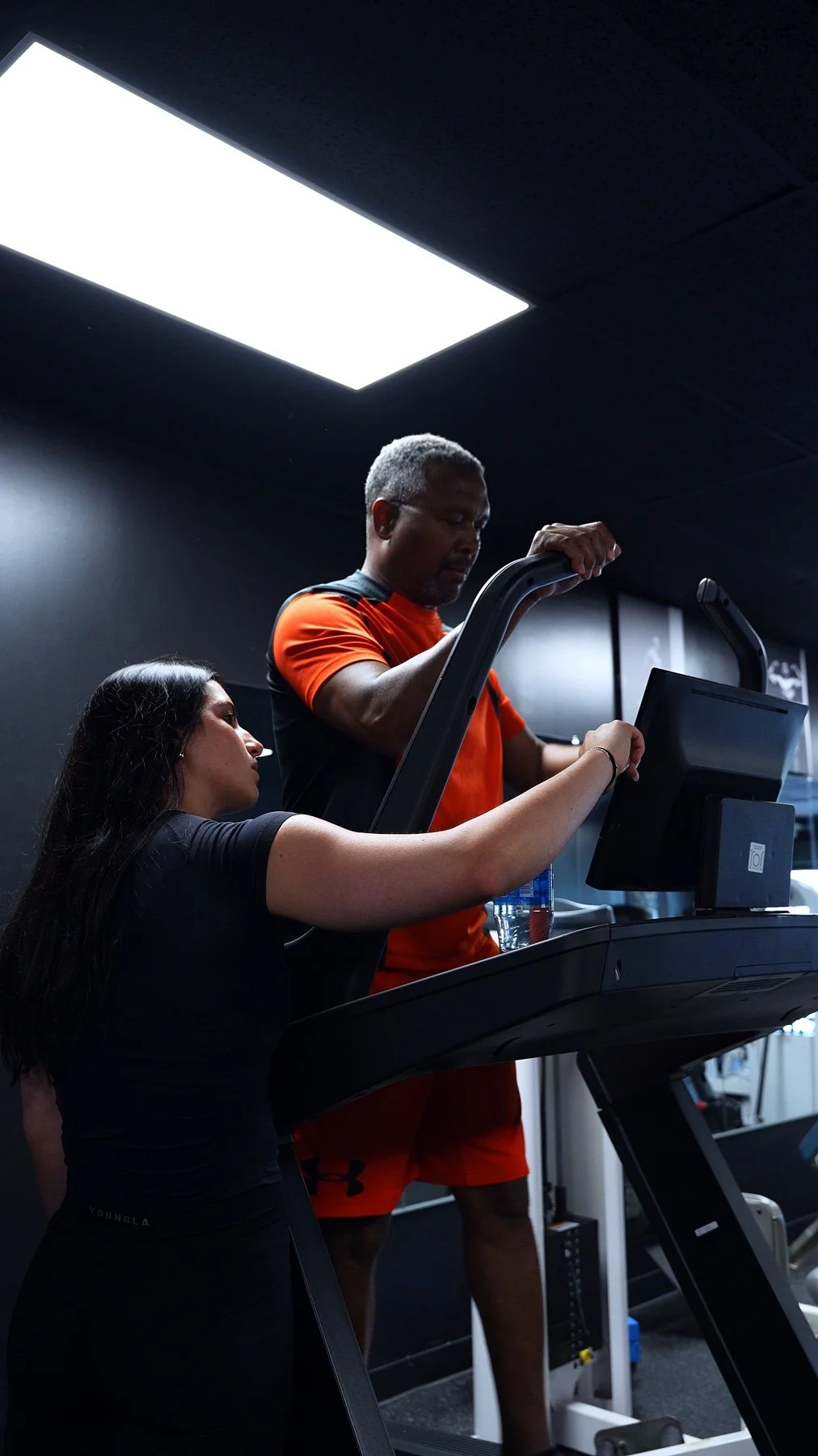 Mary coaching a client and guiding the exercise settings
