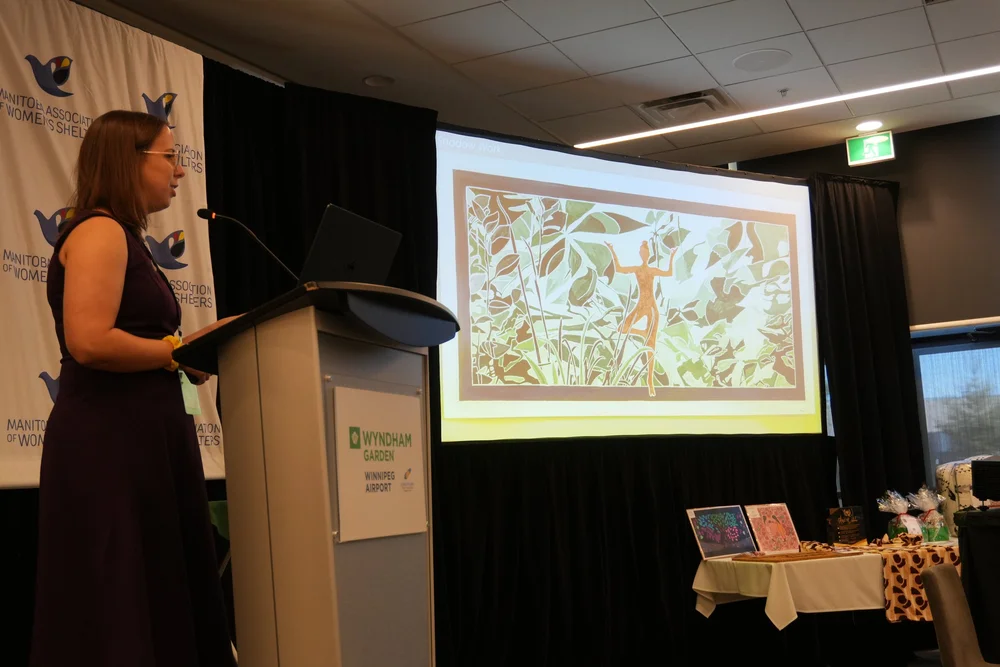 Monica sharing a painting with the symposium audience
