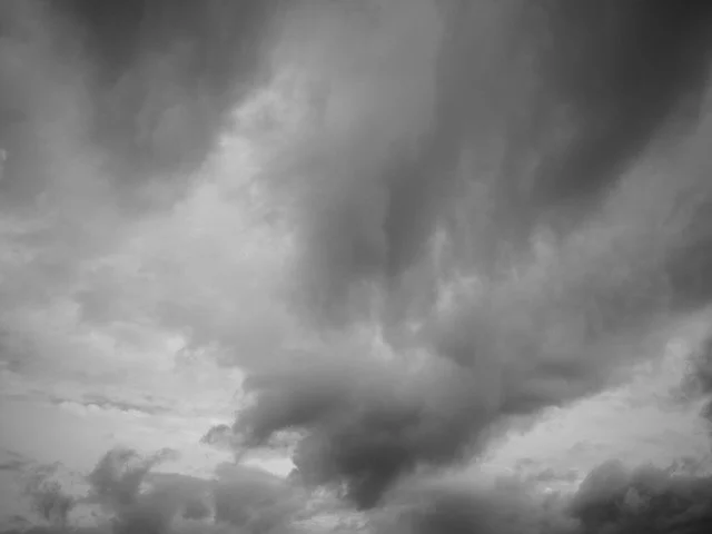 Photograph of storm clouds on a spring day in black and white - image by Reed Pike