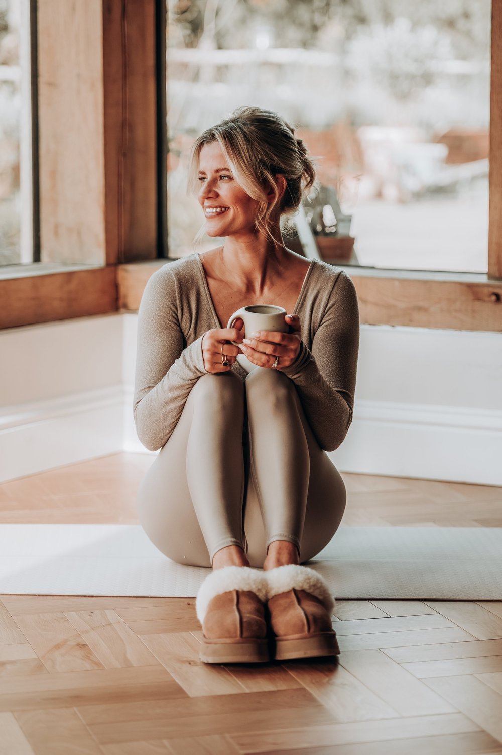 Gen, founder of The Barre Coach, smiling with a mug of tea