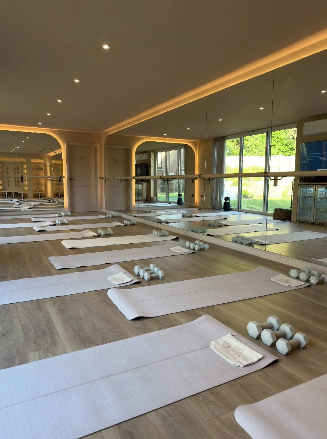 The Barre Coach studio in Cobham, set up for class with mats and weights