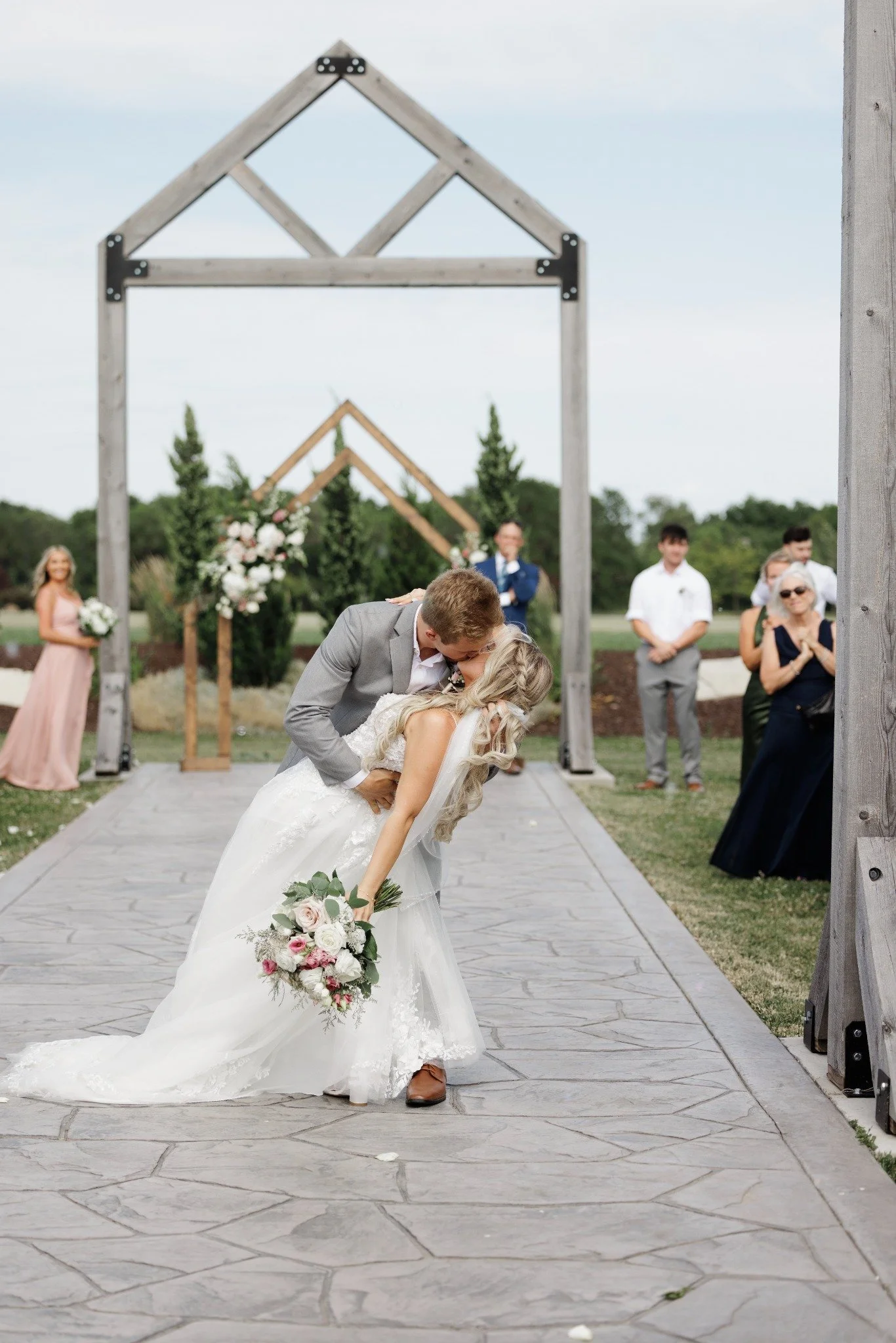 Wedding ceremony with guests gathered along the outdoor 75-foot aisle