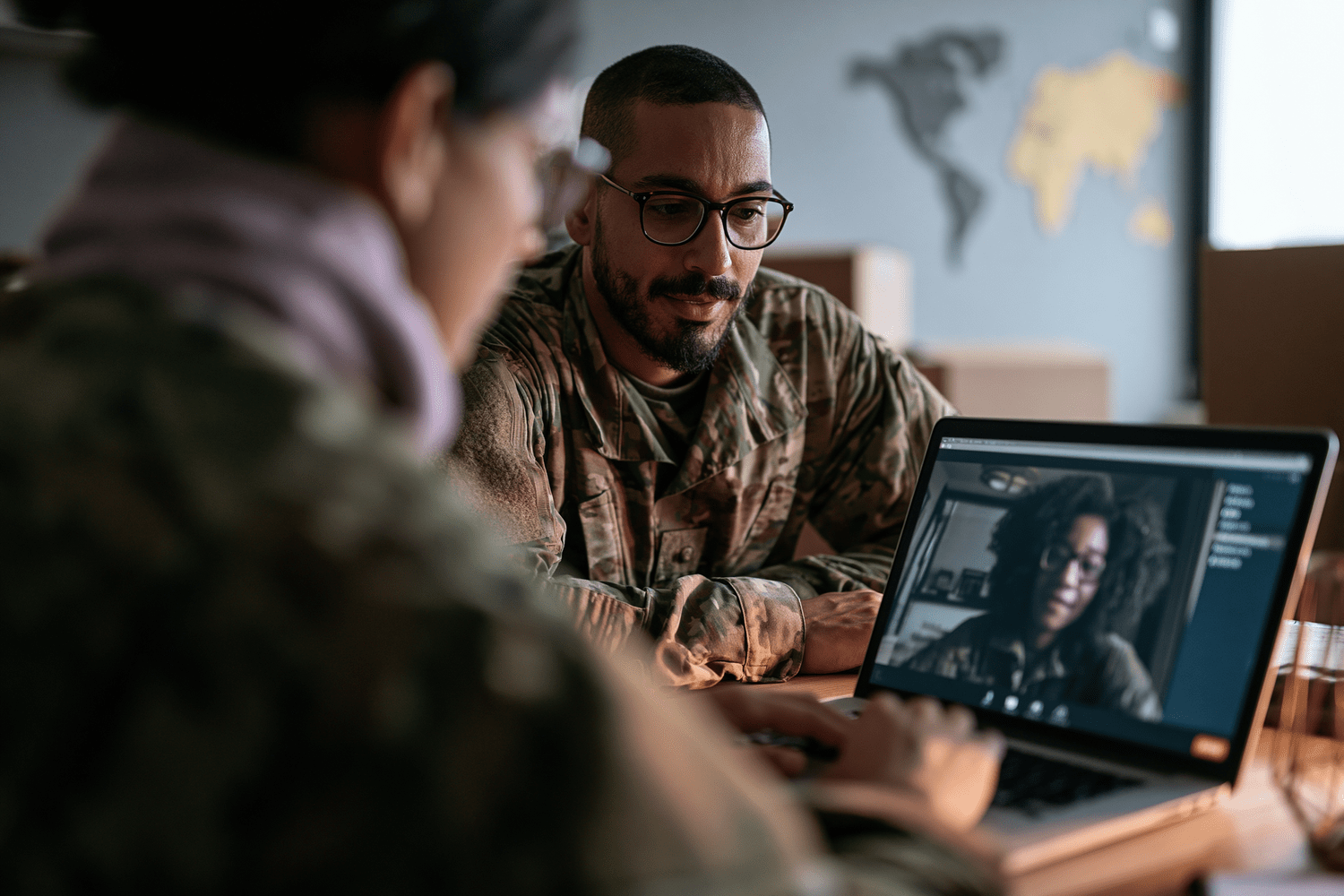 Service member and spouse on an overseas installation meeting remotely with a veterans benefits adviser.