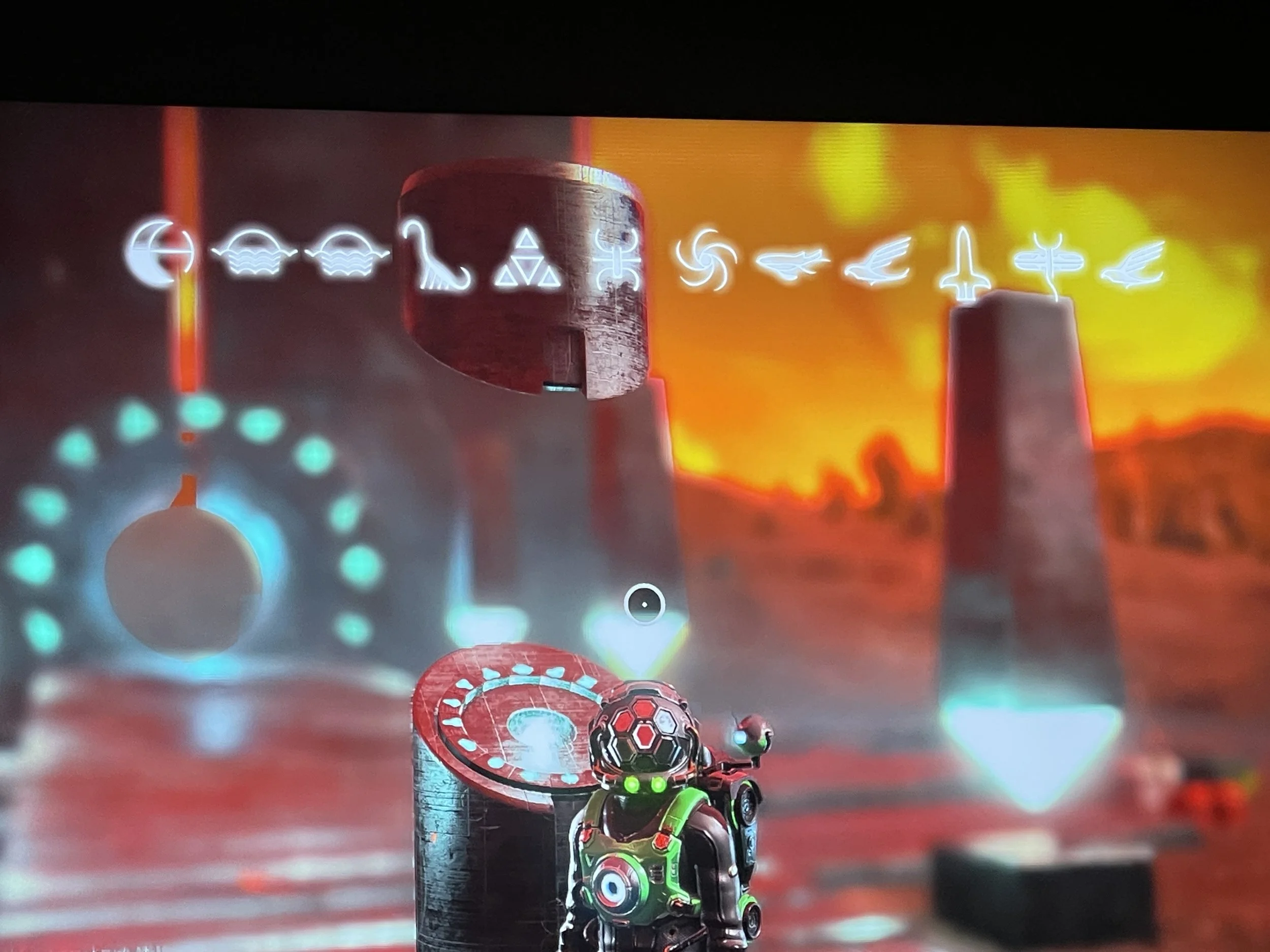 No Man’s Sky Traveller standing near an alien portal with glyphs visible on screen